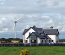 Image:  Wind turbines in a field next to a house