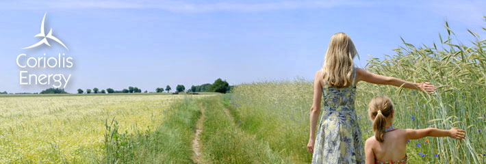Image:  Two girls walking at the edge of a wheat field