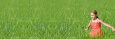 Image:  Girl in red dress running through green field